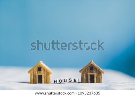 Miniature house model with "HOUSE" alphabet cube letter
