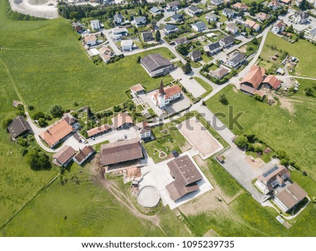 Aerial view of rural village in Switzerland with building and ro