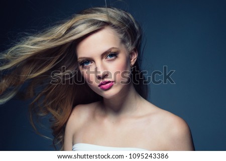 Beautiful female with long blonde curly hairstyle