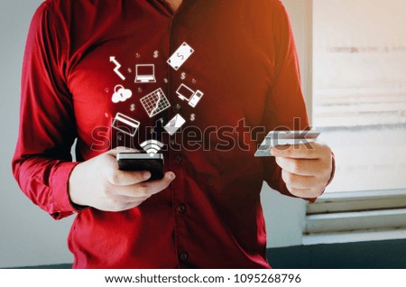 young man in red shirt entering security code with mobile phone and paying with credit card and graphic icon diagram, internet, expenses, finance, technology, payment and shopping online concept