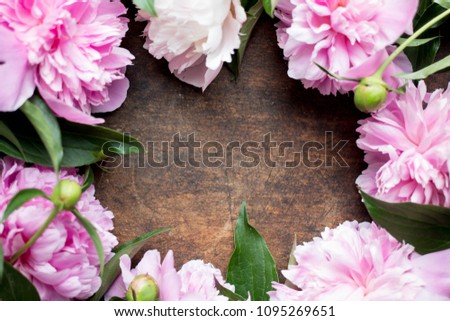 peony frame flat lay on dark wood with copy place