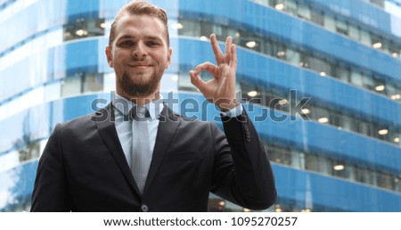 Happy Business Man Posing and Smiling Presentation while Showing Ok Sign Hand Gesture, Corporate Person Looking Camera Standing in Front of Corporation Office Building