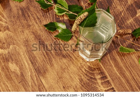 Glasses of birch sap juice birch branches on wooden table background. Healthy and vitamin food spring useful vitamin nutrition fresh drink.