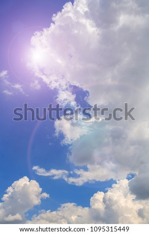 Deep blue sky and summer sun with flare and rainbow ring. Nature airscape.