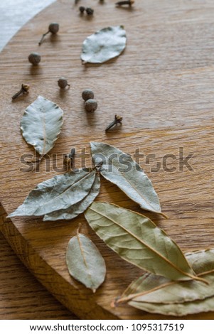 Herbs and spices on a wooden board. Close up.
