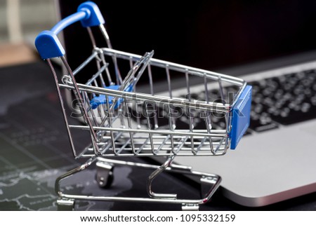 close up of Cart on keyboard computer with tablet background (Online shopping)