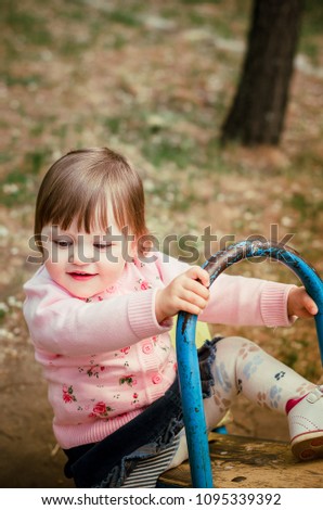 Photo of a child in poppies. Photo of a child on a swing
