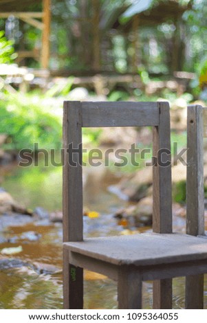 Wood Chair by Riverbank in Forest.