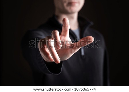 Man pointing or pressing something on black background