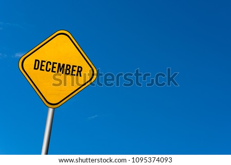December - yellow sign with blue sky
