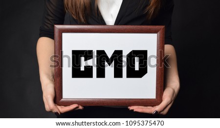 In the hands of a businessman a frame with the inscription:CMO
