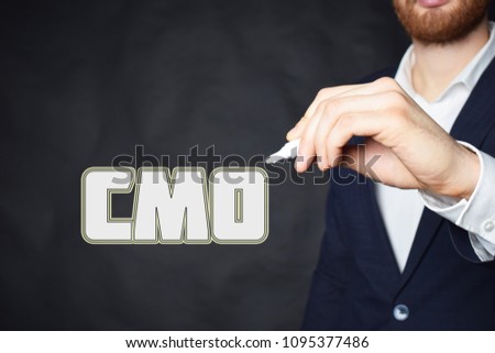 The businessman writes an inscription with a white marker:CMO