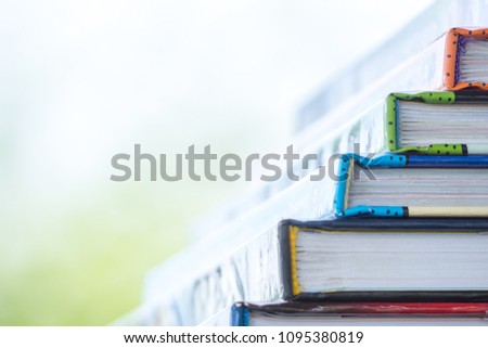 Stack of books on wood table for education and learning.