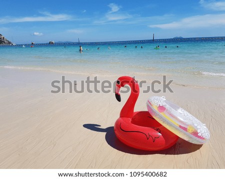 red flamingo life rign on the beach