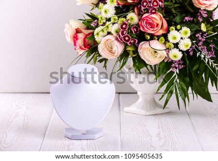 Necklace display on floral backgroung Royalty-Free Stock Photo #1095405635