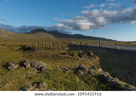 Road in the lava fields and mountains in Iceland. Beautiful summer landscape
