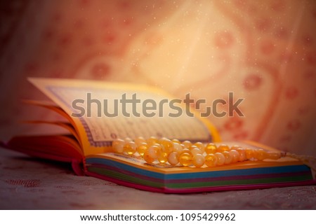 
Sacred Book of the Quran and prayer beads Royalty-Free Stock Photo #1095429962