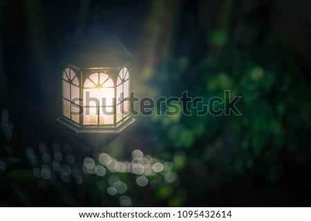 The old dirty lantern shine bright in the night garden