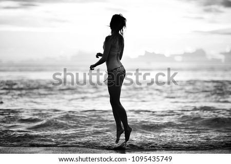 girl is having fun and jumping on beach freedom / concept freedom and summer  beach, sporty graceful girl is jumping and having fun  beach