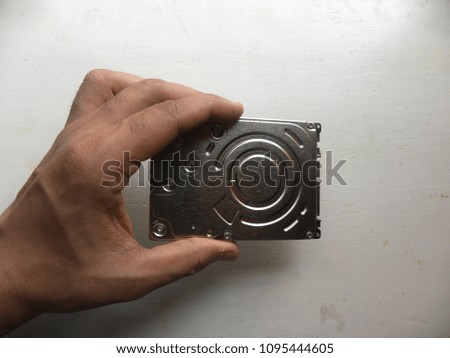 Hand of man holding internal hard disk drive of a laptop computer