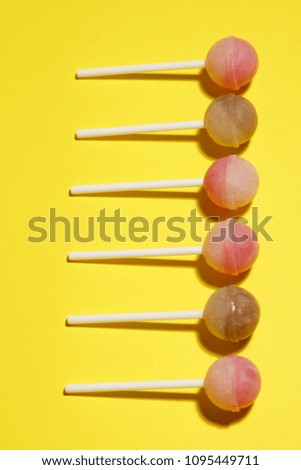 Ball lollipops on a yellow background.