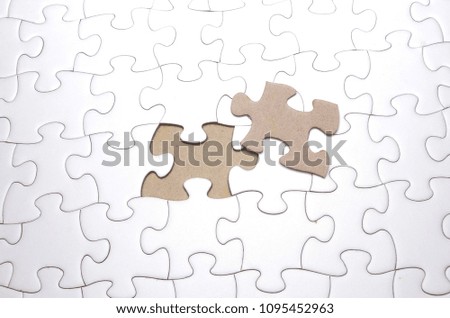 put the last piece of jigsaw puzzle to complete the mission. Selective focus.