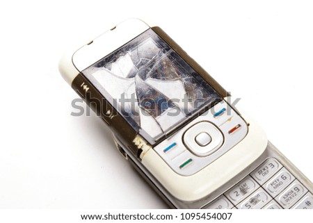 Broken mobile phone with a broken screen isolated on white background