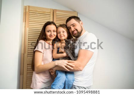 happy family at home in her room celebrating the fourth birthday of her daughter, present cat