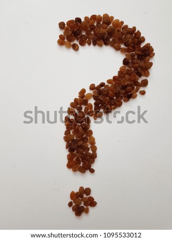 Raisins in form of question mark as an abstract background texture
