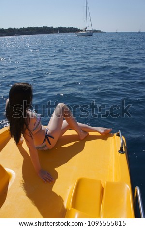 Slim girl sitting on a water bike