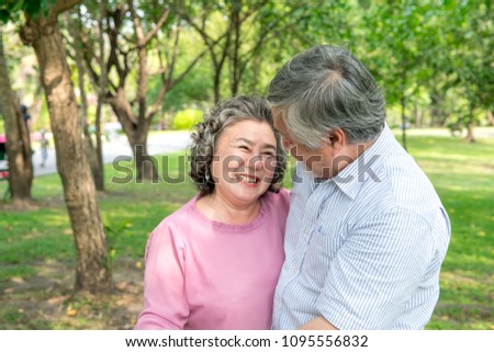 Senior couple in park. Dancing together, relaxing and loving each other with a smile