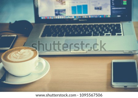 Office desk table with computer, supplies,  coffee cup, mobile phone
