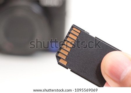 male hand holding sd memory card. Isolated on white background