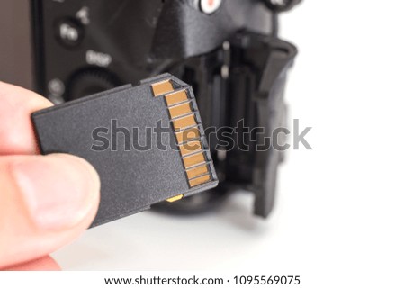 male hand holding sd memory card. Isolated on white background