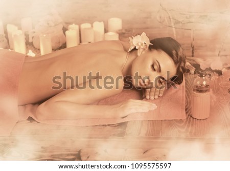 Massage of woman in spa salon. Girl on candles background in herbal steam room. Luxary interior in oriental therapy salon. Female have relax after sport. Old photo effect with sepia.
