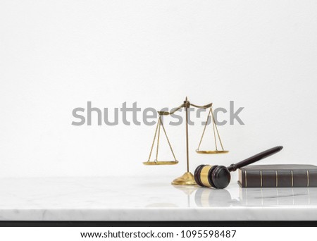 Wooden gavel and law book put on white marble table top counter with copy space.