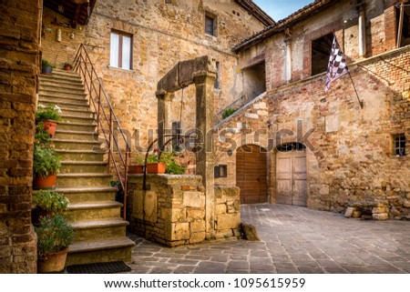 Antique well in beautiful small San Quirico Dorcia town, Tuscany Royalty-Free Stock Photo #1095615959