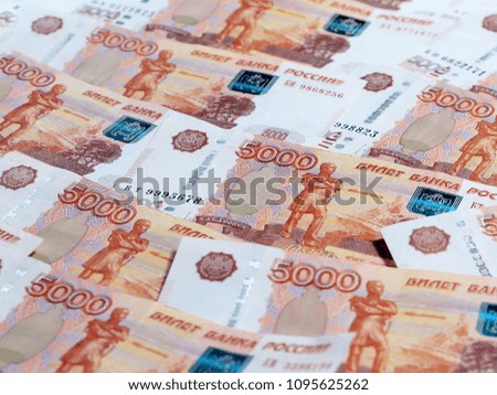 a pile of Russian paper denominations with a nominal value of five thousand rubles