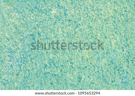Seamless texture of rough concrete wall light green-blue.