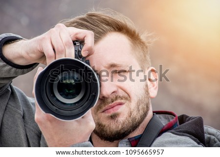 High end camera user.  Camera operator. Photographing the photographer. Royalty-Free Stock Photo #1095665957