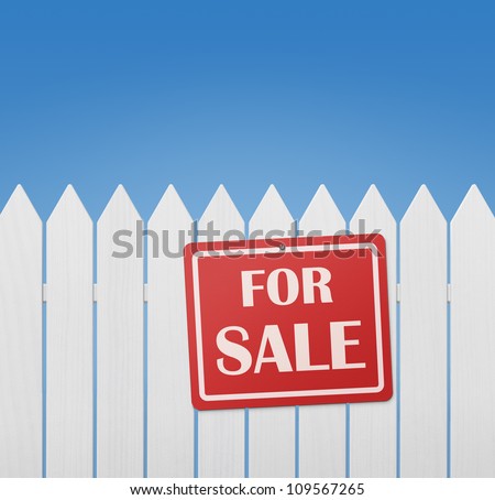 For sale sign on white wooden fence against the blue sky with copy space