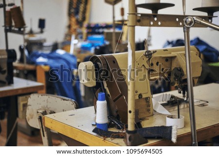 Image of a tailor's workplace with a sewing machine at a sewing workshop.