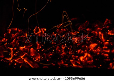 A beautiful horizontal texture of a burning fire on a black background with sparks
