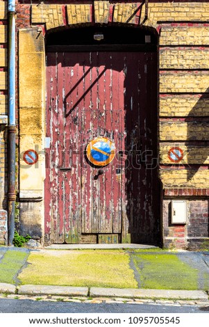 Old door with chipping paint and no parking sign