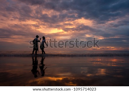 a couple seeing the sunset on the beach