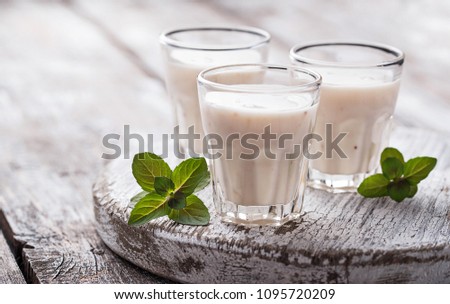 White Greek yogurt on light wooden table. Selective focus