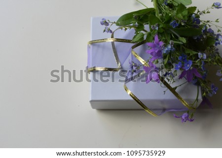 Still life with blossom and shaped gift box.