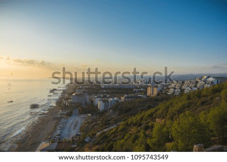 Background colorful sky concept: Dramatic sunset with clouds, overlooking the city. Alanya, Turkey, the Mediterranean Sea. Panoramic