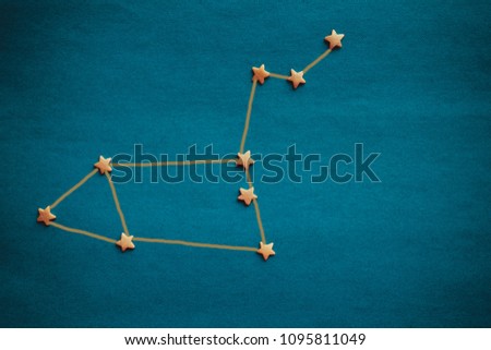 On a blue background, the schematic arrangement of the stars, the constellation Leo. Horoscope, the influence of stars on fate. The picture is made by the author, vignetting.