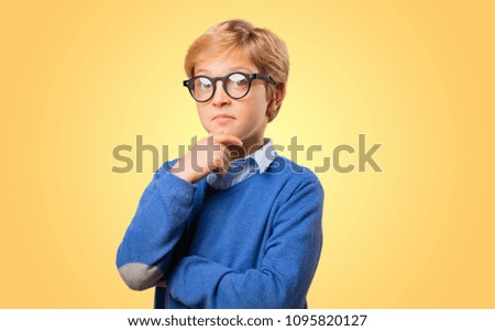 young blonde boy thinking or having an idea